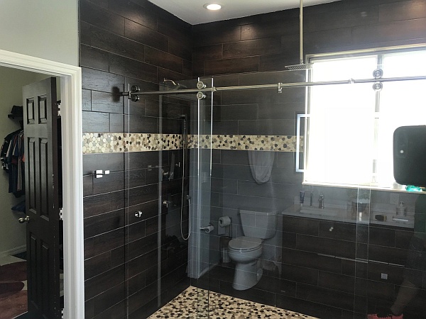 glass shower enclosure with glass sliding barn door